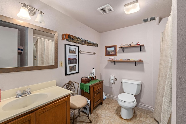 bathroom with toilet and vanity