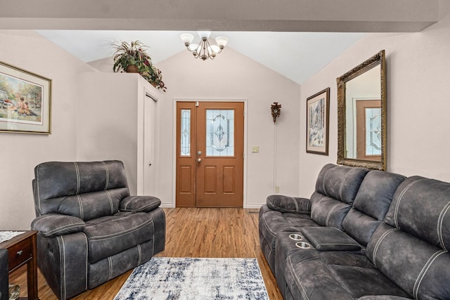 living room with lofted ceiling with beams, light hardwood / wood-style flooring, and a notable chandelier