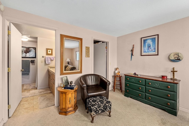 sitting room featuring light colored carpet