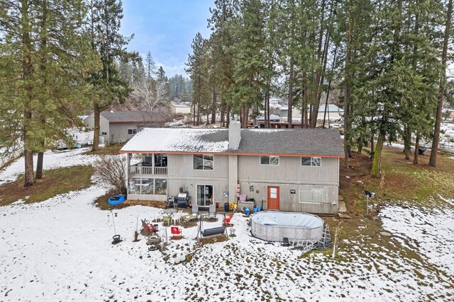 view of snow covered rear of property