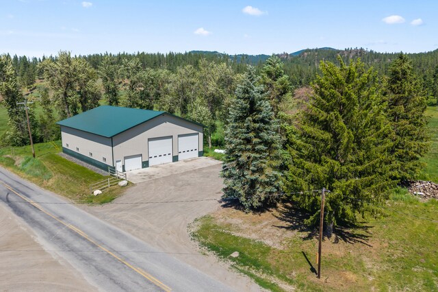 2829 Cottonwood Creek Rd, Chewelah, WA 99109 - back of property featuring a deck with mountain view and a shingled roof