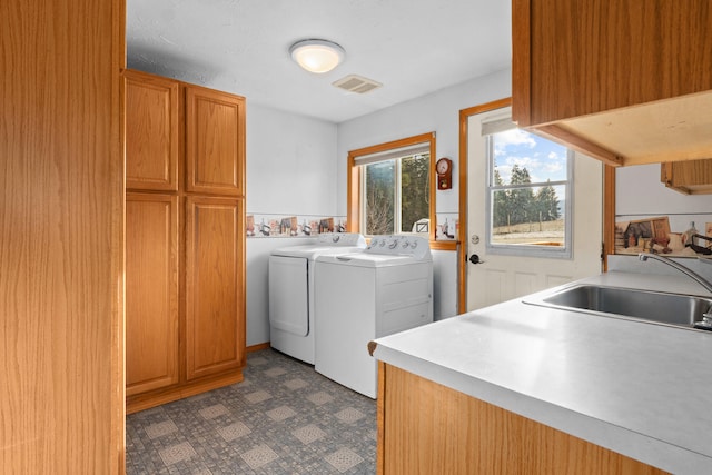2829 Cottonwood Creek Rd, Chewelah, WA 99109 - laundry area with washing machine and dryer, cabinet space, and dark flooring