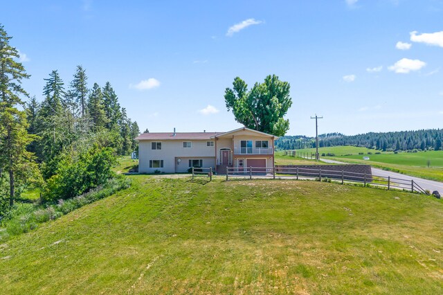 2829 Cottonwood Creek Rd, Chewelah, WA 99109 - back of house featuring an attached garage and a view of rural / pastoral area