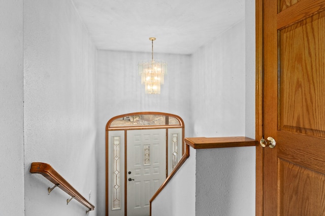 2829 Cottonwood Creek Rd, Chewelah, WA 99109 - stairway featuring a chandelier and a textured wall