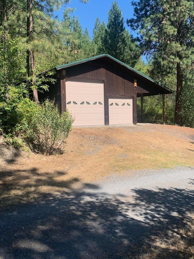 59 Bisbee Creek Ln, Kettle Falls, WA 99141 - garage featuring a detached garage and dirt driveway