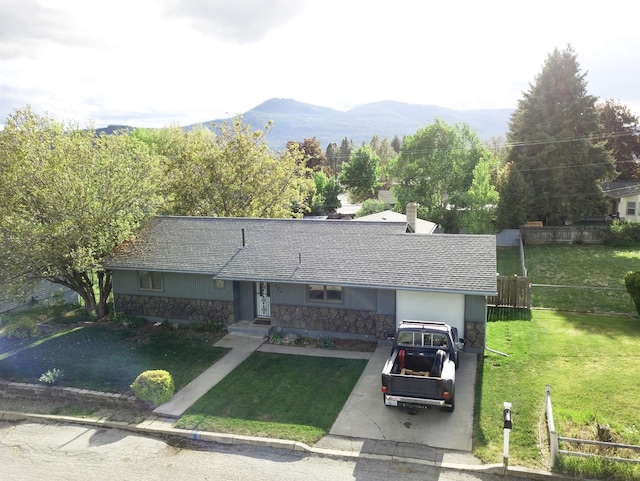 824 S Chester St, Colville, WA 99114 - ranch-style house featuring stone siding, a garage, a mountain view, and a shingled roof