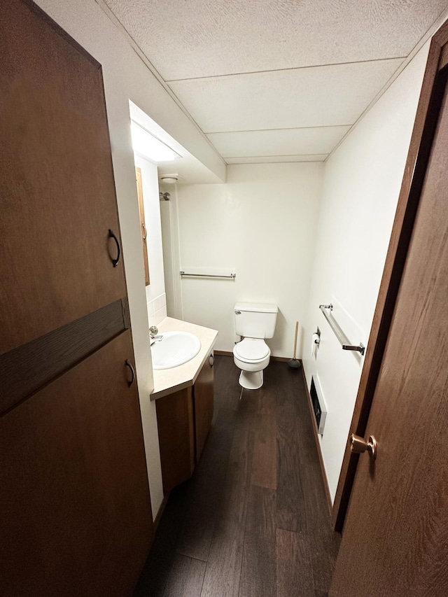 824 S Chester St, Colville, WA 99114 - bathroom with toilet, wood finished floors, vanity, and baseboards