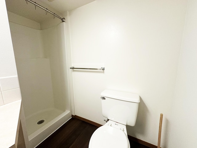 824 S Chester St, Colville, WA 99114 - full bath with wood finished floors, a stall shower, toilet, and baseboards