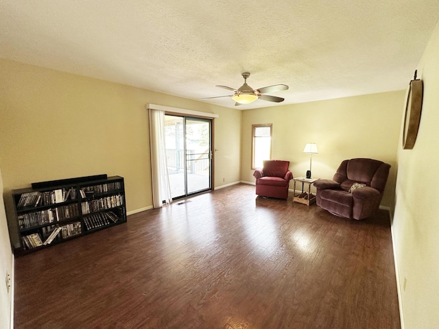 824 S Chester St, Colville, WA 99114 - sitting room featuring dark wood-style flooring, ceiling fan, baseboards, and a textured ceiling