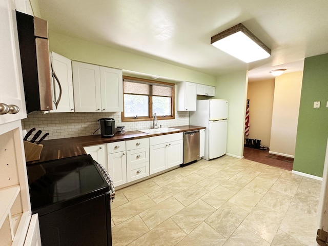 824 S Chester St, Colville, WA 99114 - kitchen with electric range, dishwasher, a sink, freestanding refrigerator, and decorative backsplash