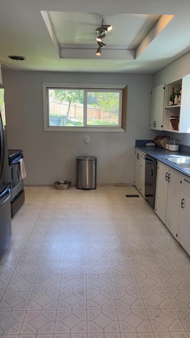 980 N Elm St, Colville, WA 99114 - kitchen with dark countertops, electric range, open shelves, stainless steel dishwasher, and white cabinets