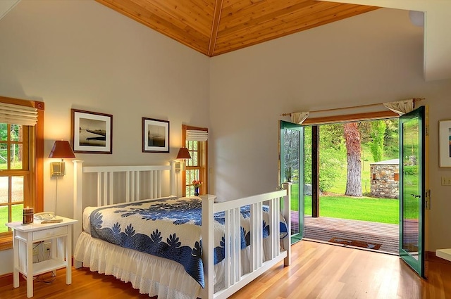 bedroom featuring wooden ceiling, access to outside, high vaulted ceiling, and wood finished floors