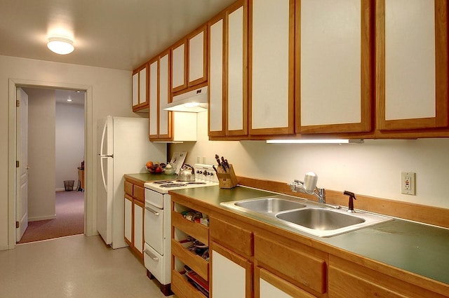 kitchen featuring white appliances, under cabinet range hood, glass insert cabinets, and a sink