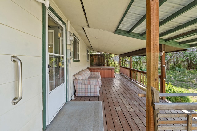 wooden deck with a hot tub
