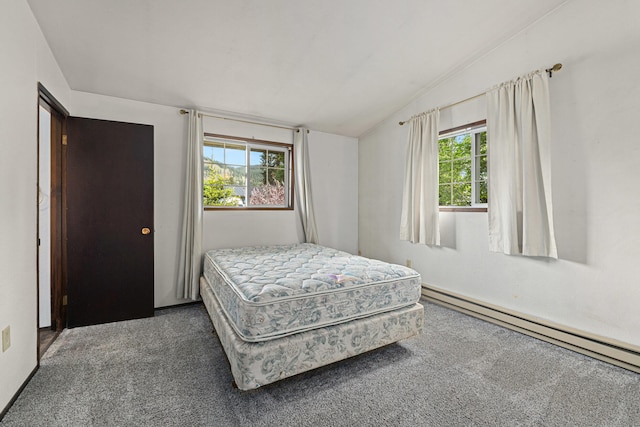 bedroom featuring lofted ceiling, baseboard heating, carpet floors, and multiple windows