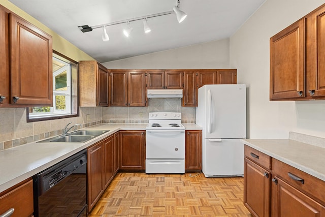 kitchen featuring white appliances, under cabinet range hood, a sink, lofted ceiling, and rail lighting