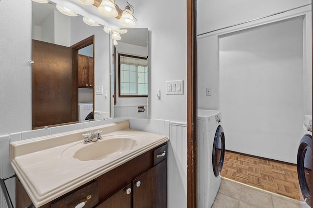 bathroom with washer / dryer and vanity