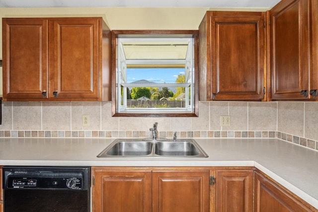 kitchen featuring black dishwasher, a sink, light countertops, decorative backsplash, and brown cabinets