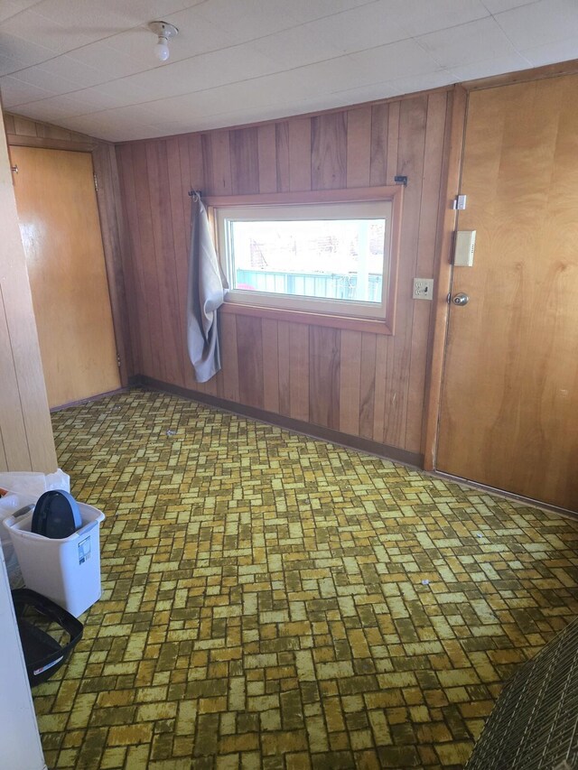 901 N 3rd St E, Chewelah, WA 99109 - empty room featuring wood walls and brick floor