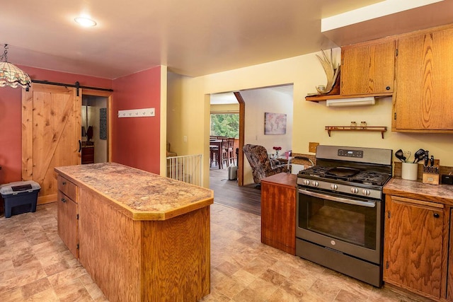 kitchen with a center island, gas range, and a barn door