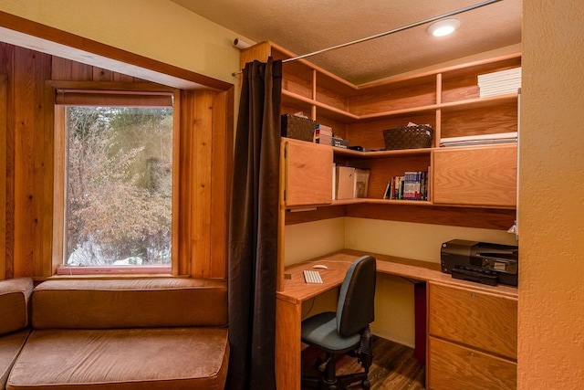 unfurnished office featuring built in desk and a textured ceiling