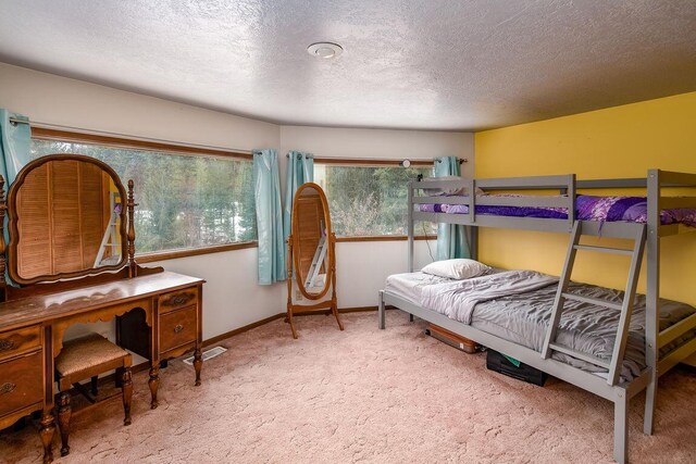 bedroom with a textured ceiling and carpet floors