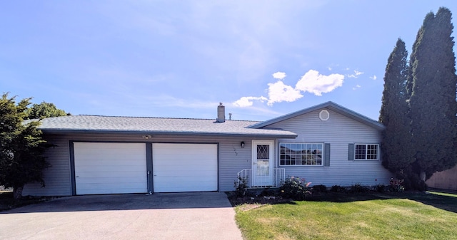 1262 E Elep Ave, Colville, WA 99114 - single story home featuring a garage, concrete driveway, a front lawn, and a chimney