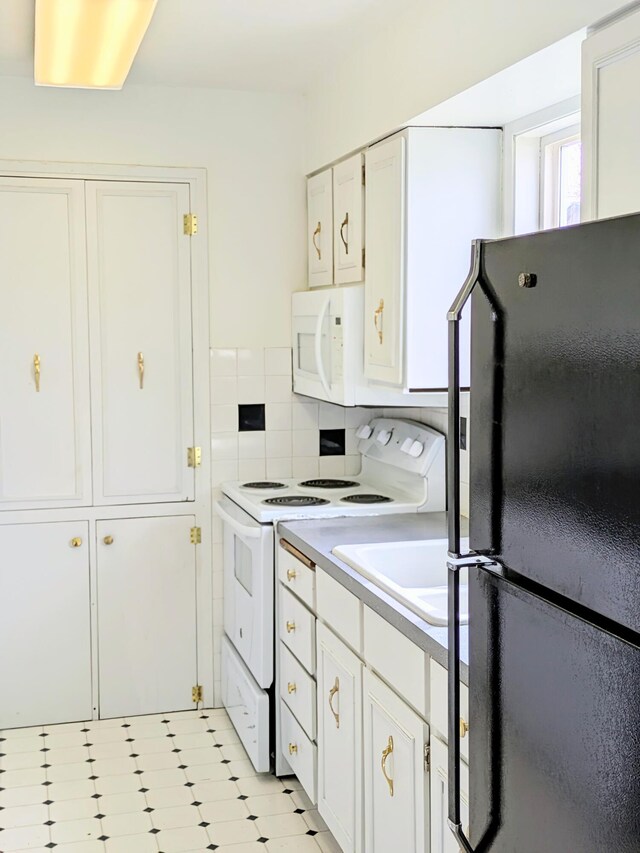 1262 E Elep Ave, Colville, WA 99114 - kitchen featuring white appliances, white cabinetry, light countertops, and a sink