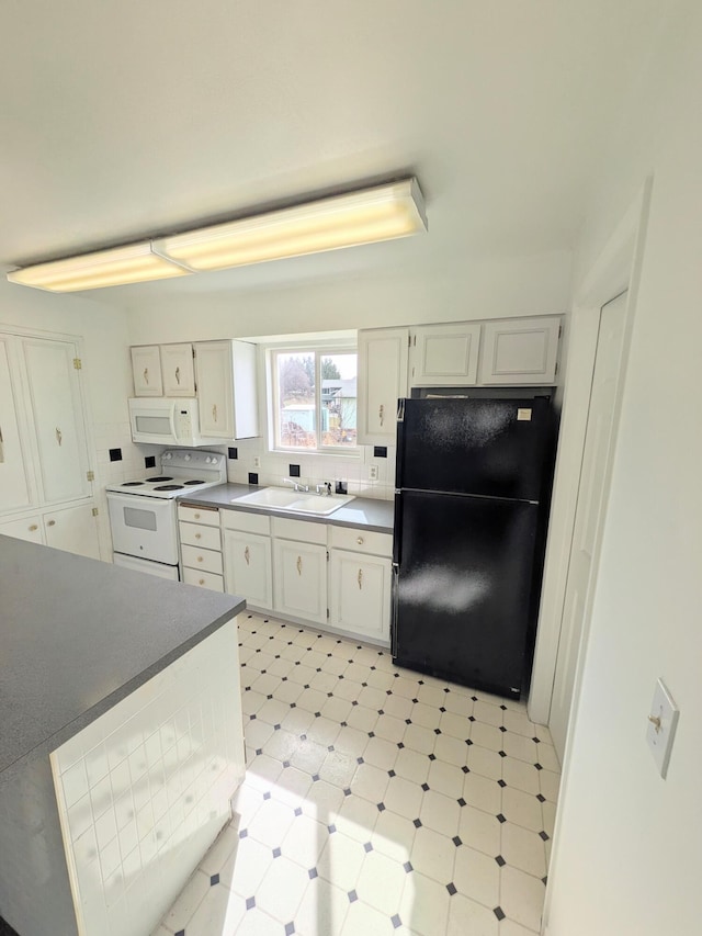 1262 E Elep Ave, Colville, WA 99114 - kitchen featuring white appliances, light floors, white cabinets, and dark countertops