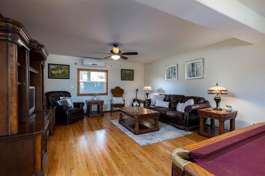 3439 Northport Flat Creek Rd Unit B, Kettle Falls, WA 99141 - living room featuring a wall mounted AC, light wood finished floors, ceiling fan, and billiards table