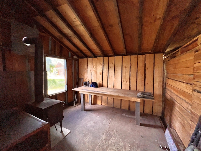 miscellaneous room featuring vaulted ceiling and wooden walls