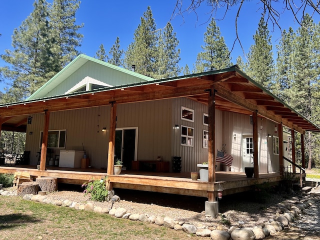 rear view of house featuring a wooden deck