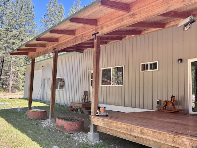 exterior space featuring board and batten siding and a wooden deck