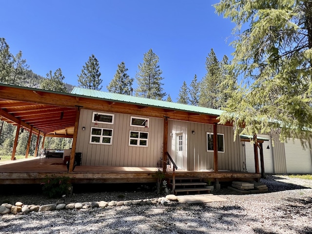 rear view of property with metal roof