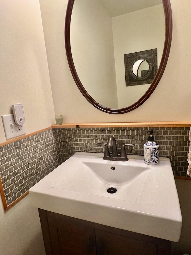 bathroom featuring a wainscoted wall, tile walls, and vanity