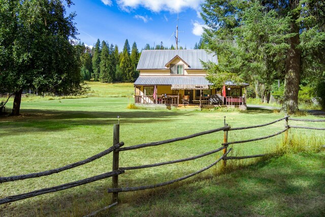 back of house featuring an outbuilding and a lawn