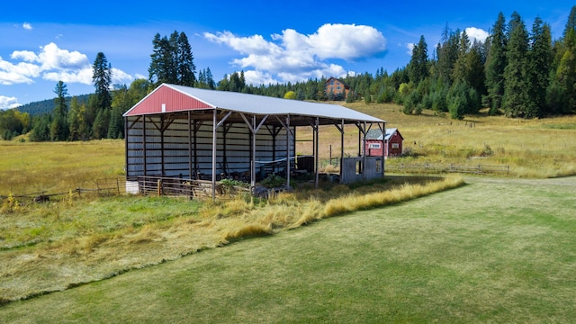 view of home's community with an outbuilding and a rural view