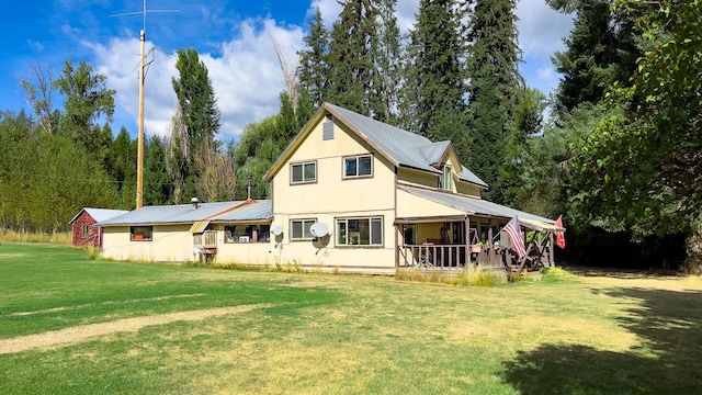 back of house with a porch and a lawn