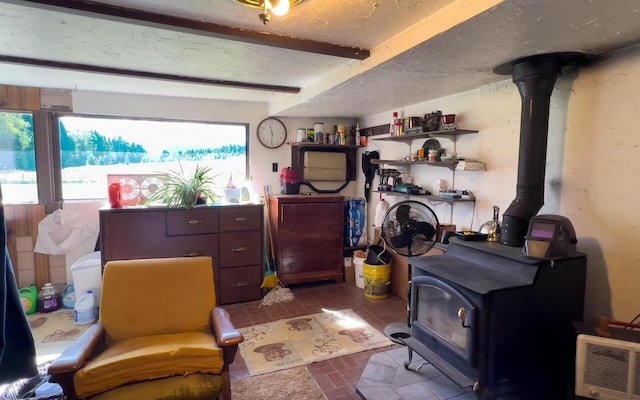 interior space featuring a wood stove and a textured ceiling