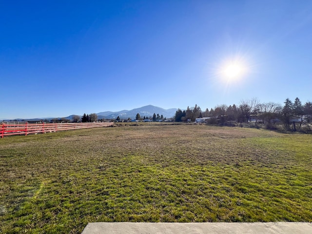 view of yard featuring a rural view and a mountain view