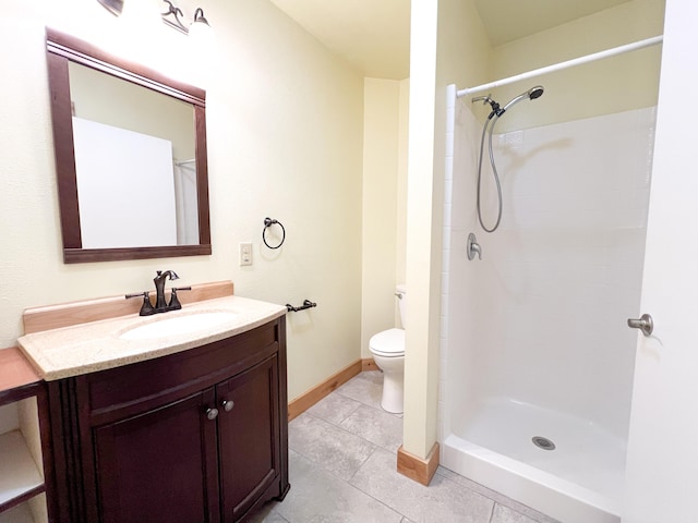 bathroom featuring tile patterned flooring, vanity, walk in shower, and toilet