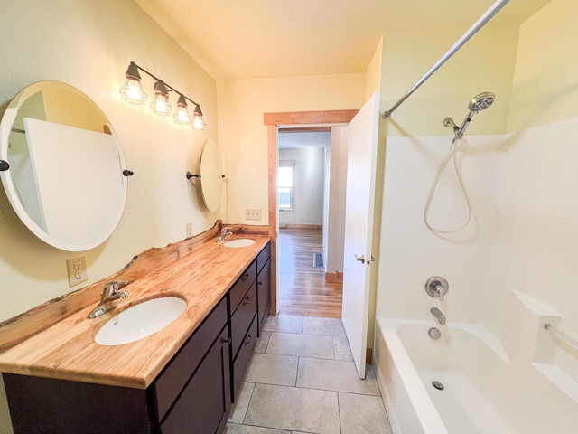 bathroom with bathing tub / shower combination, tile patterned floors, and vanity