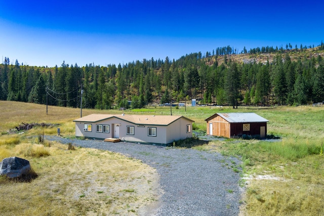 birds eye view of property featuring a forest view