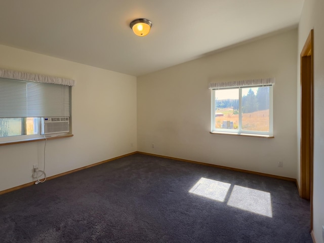 carpeted empty room with lofted ceiling, baseboards, and cooling unit