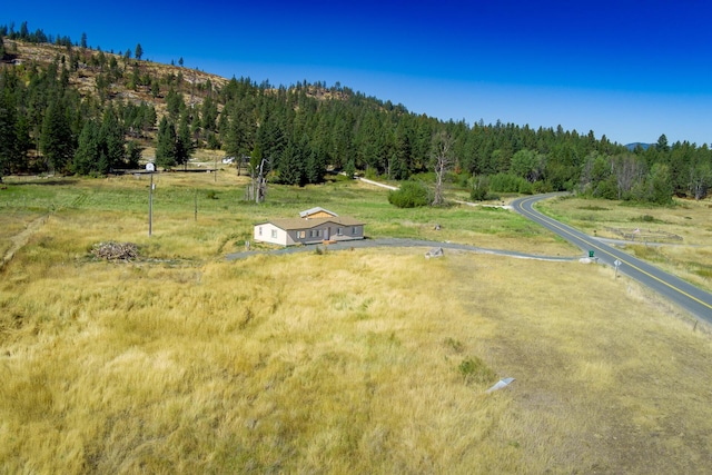 bird's eye view with a rural view and a wooded view