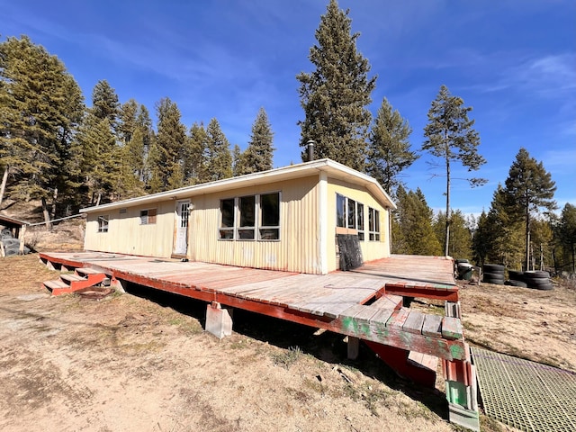 rear view of property featuring a deck