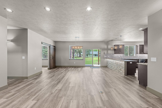 231 Hogans Way, Chewelah, WA 99109 - unfurnished living room with light wood-style floors, a textured ceiling, and recessed lighting