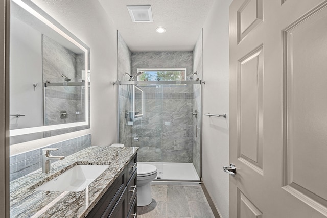 231 Hogans Way, Chewelah, WA 99109 - full bath featuring a stall shower, vanity, a textured ceiling, and recessed lighting