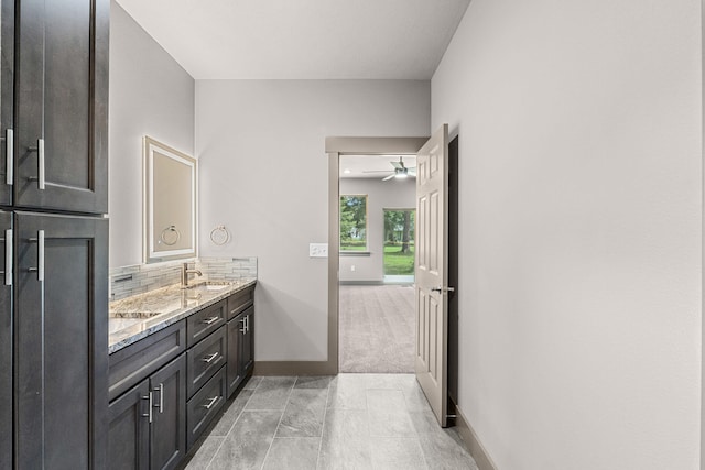231 Hogans Way, Chewelah, WA 99109 - bathroom with double vanity, backsplash, and ceiling fan