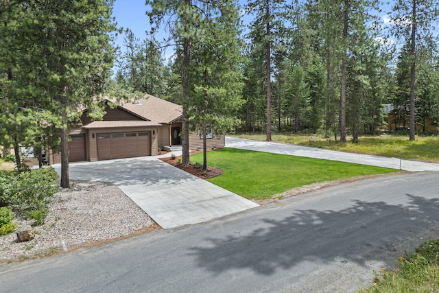 231 Hogans Way, Chewelah, WA 99109 - view of front facade featuring concrete driveway, a front lawn, a garage, and a shingled roof